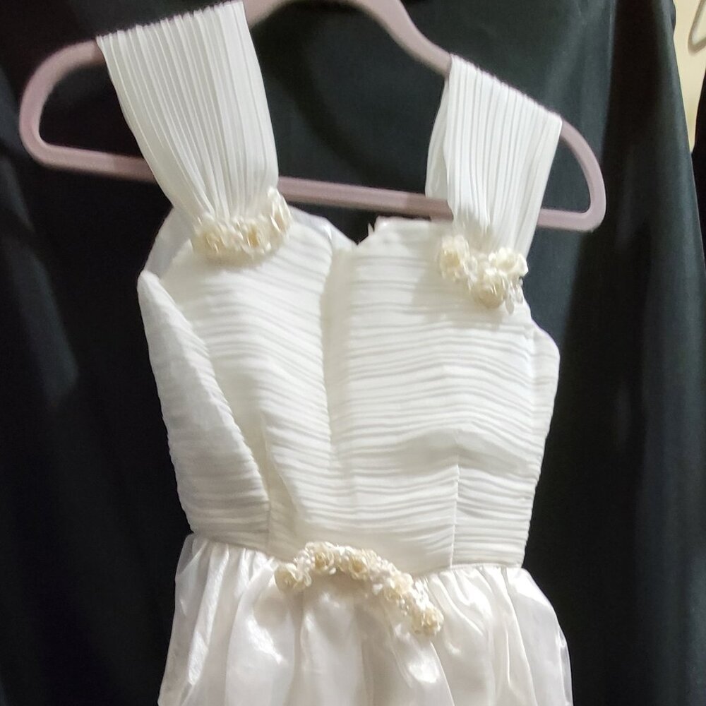 A pair of custom, hand made cute dresses